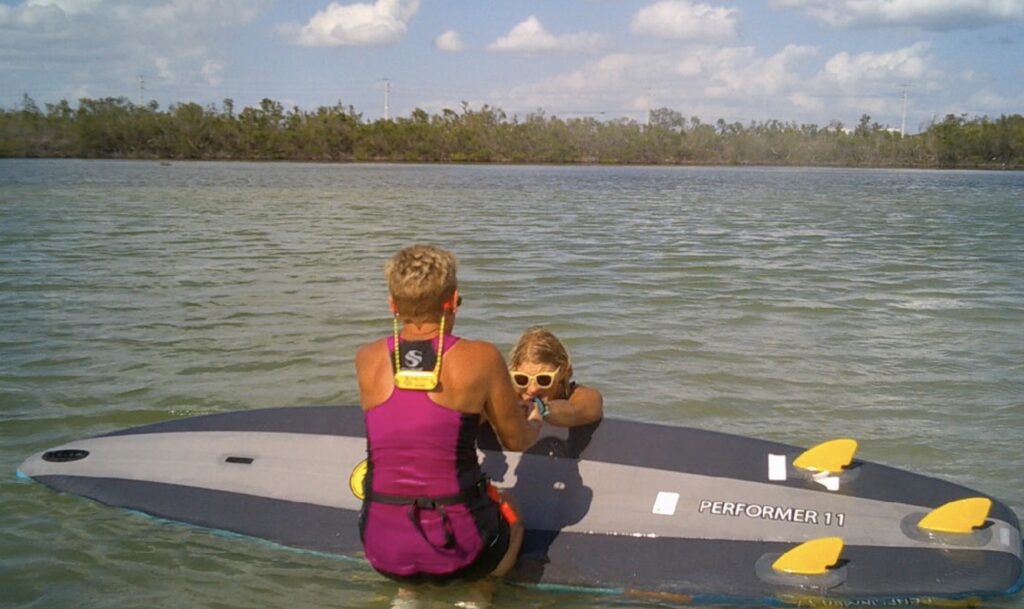 2 students practicing rescue flip on paddle boards - image